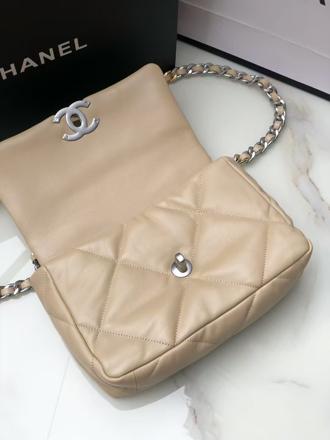 Ch*el 19 handbag shiny leather, gold-tone, silver-tone & ruthenium-finish metal beige 26x16x9cm
